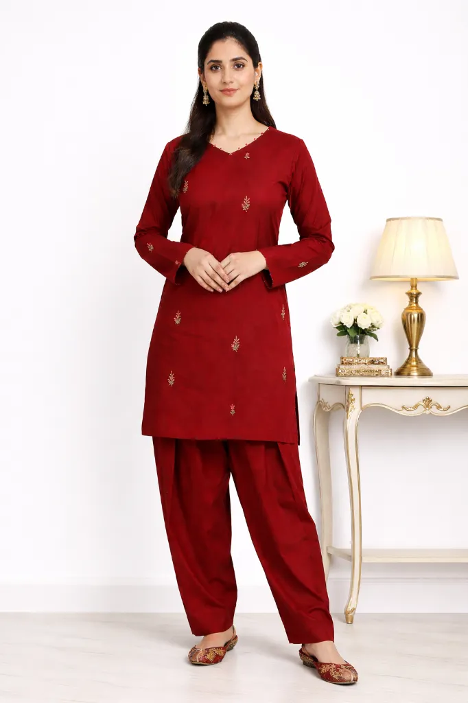 Elegant woman in red by console table.webp